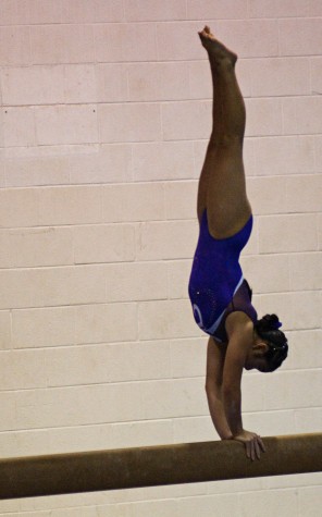 Tianna Morimoto performs a dismount off the beam. (Photo by Susan Dabritz/SeaPics.com)