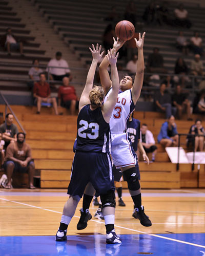 Hilo's Hotia Vaaimamao takes a short jumper over NDNU's #23 Jennifer Dreessen.