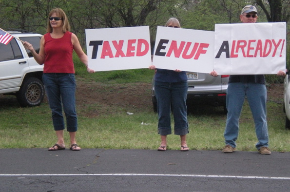 taxteaparty1 Three protesters join together to make their message heard Wednesday in Kona during the Tax Day Tea Party. (Hawaii247.com photo by Karin Stanton)