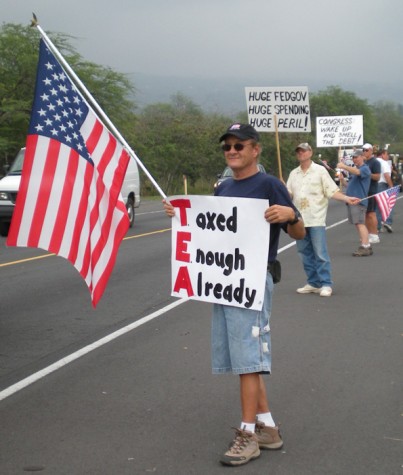 taxteaparty5 Dozens of flags and signs greeted drivers along Queen Kaahumanu Highway during the Tax Day Tea Party. (Hawaii247.com photo by Karin Stanton)