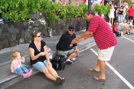 paradekenoi Mayor Billy Kenoi greets parade watchers along Alii Drive.