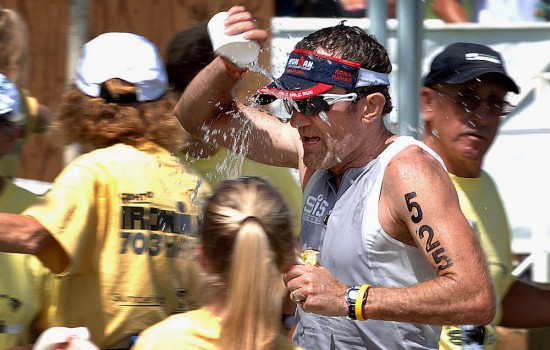 Sean Kennedy powers through an aide station during Saturday's Ironman 70.3 triathlon.