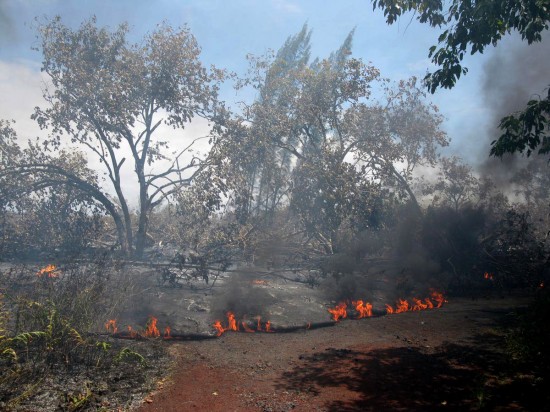 The air was thick with smoke from burning vegetation and asphalt late Saturday. Flows here were crossing Highway 137 and moving slowly toward the residence, which burst into flames about 3:30 a.m. Sunday. (Photo courtesy of Hawaiian Volcano Observatory)