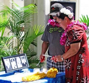 oili-family Daniel Oili and Raynette Taketa, descendants of William "Red" Oili, light candles in his honor and for three other Big Island police officers who have been killed in the line of duty since 1918.