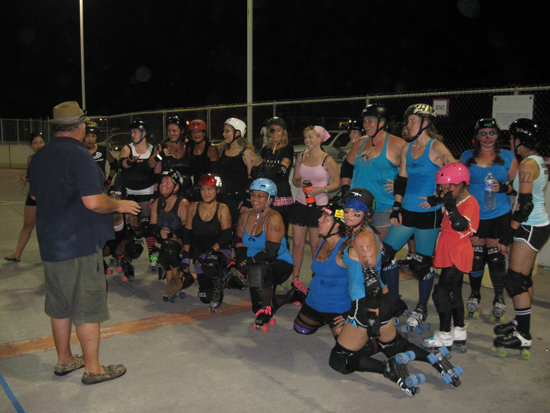 Blue team coach Papa Lolo speaks to the players at the end of the scrimmage.