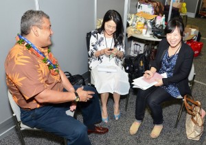 Hawaii County Mayor Billy Kenoi speaks to two reporters from the Guangzhou Daily News, the world's 24th largest newspaper in the world during the Asia Pacific Economic Cooperation summit Wednesday (Nov 9) in Honolulu.