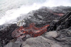20111213_usgs-lava-down-cliff2 This photograph shows two channels of lava coming over the sea cliff, reaching the new lava delta. Photo courtesy of USGS/HVO