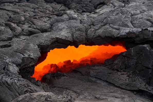 This skylight provided a clear view of the lava stream inside the lava tube on today's overflight, and a swiftly moving current could easily be seen. Photo courtesy of USGS/HVO