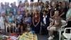 The Aloha Quilters present a custom crafted quilt to a family who has a home being built by Habitat for Humanity West Hawaii in Kawaihae.