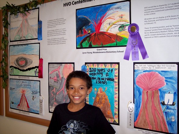 VW_20120208_ HVO Posters_Grand Prize Hawai`i Island 4th grade student Jyron Young was awarded the Grand Prize in HVO’s centennial poster contest for his stunning artwork depicting 100 years of volcano watching (top center). USGS photo.