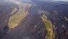 Lava flows creep through the Royal Gardens subdivision on February 24, 2012, slowly burying the few remaining forested kipuka. Photo courtesy of USGS/HVO