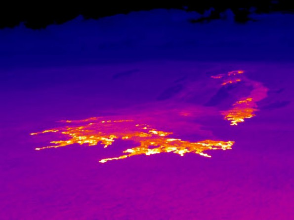 20120521_usgs-coastal-plain-pali-thermal This thermal image, looking northwest, shows the extent of the active breakouts on the coastal plain and pali. White and yellow areas depict active breakouts. A wide area of breakouts comprises the flow front on the coastal plain. On the pali, several breakout areas were active in Royal Gardens subdivision, and the easternmost of these breakouts has sent a flow onto the coastal plain in the past week. Photo courtesy of USGS/HVO
