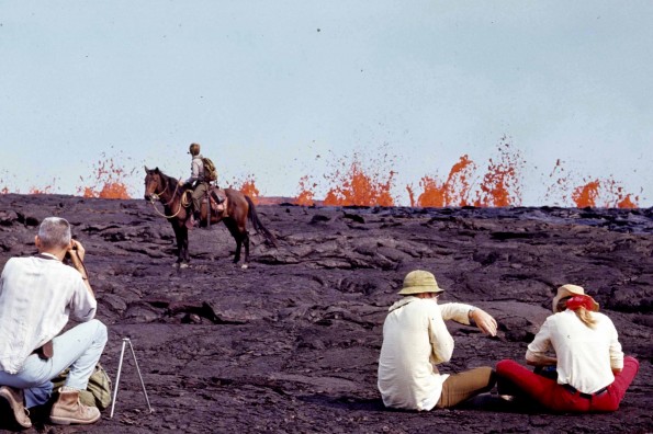 As erupting fissures migrated down Kilaueaʻs southwest rift zone in September 1971 for the first time in 52 years, many spectators hiked into the Ka`u Desert for a closer view of the rare event. Hawai`i Volcanoes National Park rangers patrolled the area on horseback to keep people a safe distance from the lava fountains. Photo courtesy of NPS.