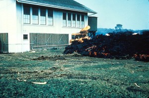 Hawaii Volcanoes National Park. 1960 eruption of Kilauea Volcano. Aa lava flow at the school in Kapoho. January 1960. Photo courtesy of USGS