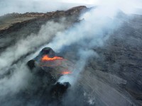 A small collapse Friday morning (Dec 14) of the spatter cone that had built up around the northeast lava pond in Puʻu ʻŌʻō resulted in a brief gush of lava onto the crater floor. Photo courtesy of USGS/HVO