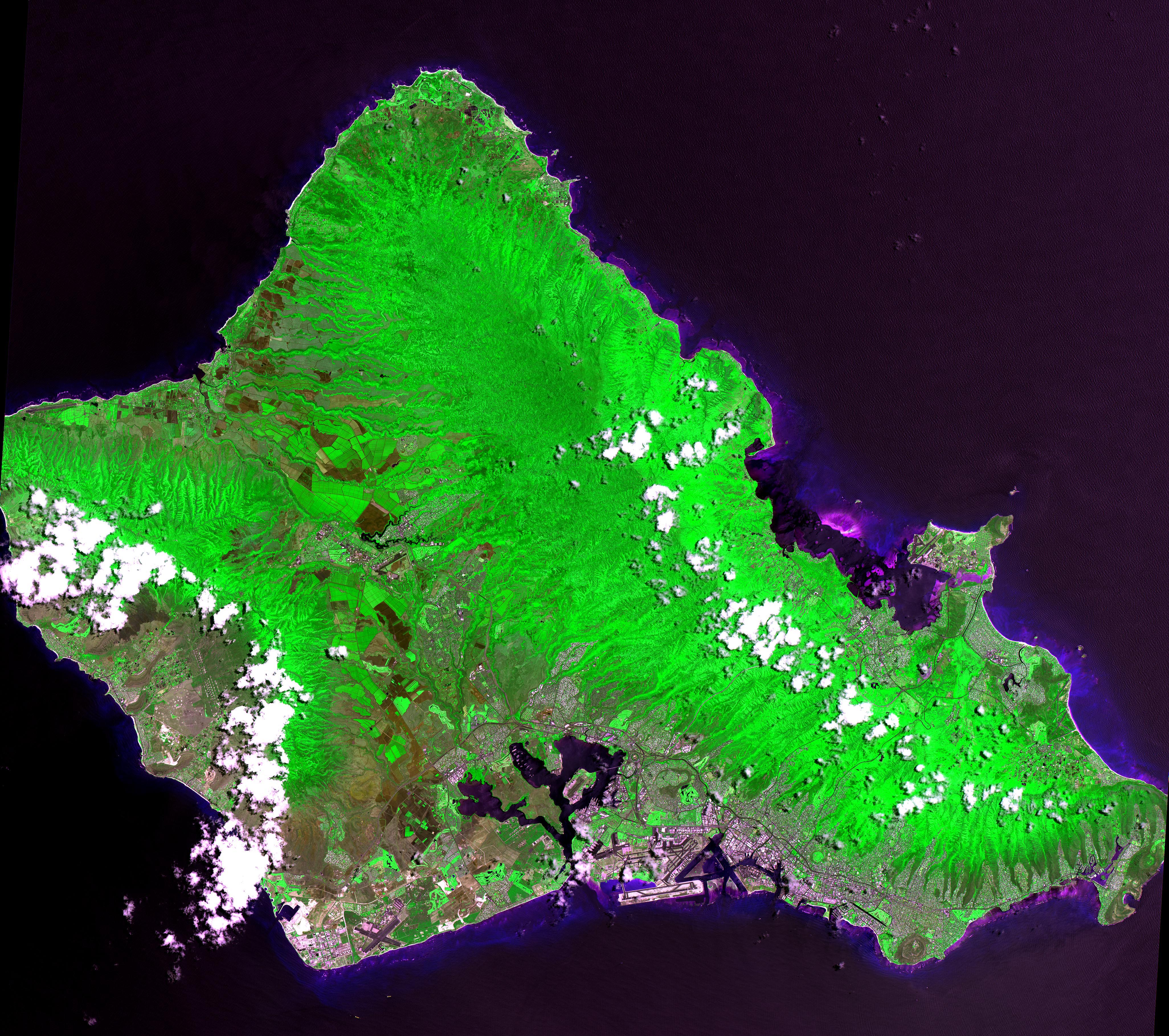 This 60 by 55 km ASTER scene shows almost the entire island of Oahu, Hawaii on June 3, 2000. Bands 2, 3, and 1 are displayed in red, green and blue, making the vegetation appear green. Oahu is the commercial center of Hawaii and is important to United States defense in the Pacific. Pearl Harbor naval base is situated here. The chief agricultural industries are the growing and processing of pineapples and sugarcane. Tourism also is important to the economy. Among the many popular beaches is the renowned Waikiki Beach, backed by the famous Diamond Head, an extinct volcano. The largest community, Honolulu, is the state capital. The image is located at 21.5 degrees north latitude and 158 degrees west longitude. NASA/GSFC/METI/Japan Space Systems, and U.S./Japan ASTER Science Team 20000603_aster-oahu