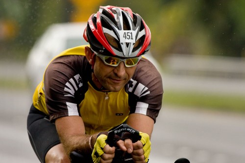 Peter Mueller Triathlete Peter Mueller rides along rainy Kanoelehua Avenue in Hilo during day two of the 2008 Ultraman Triathlon.