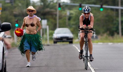 Johnny Phillips, left, jogs next to triathlete Shanna Armstrong Johnny Phillips, left, jogs next to triathlete Shanna Armstrong along the Keaau Bypass (Hwy 130) heading towards Hilo during the second day of the Ultraman Triathlon. Phillips is part of Armstrong's support team during the three day event which started and finishes in Kailua-Kona