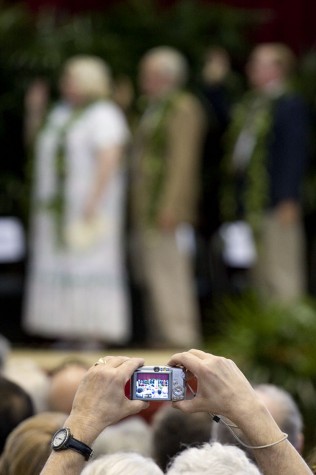 A member of the audience gets a snapshot of the Hawaii County Council taking the oath of office during inaugural ceremonies in Afook-Chinen Civic Auditorium.
