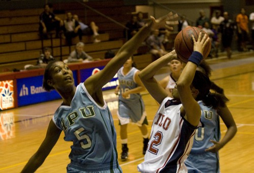 20090102_hina-kimitete-shooting UH-Hilo's Hina Kimitete (22) takes a shot over an HPU player during basektball action at Afook-Chinen Civic Auditorium.