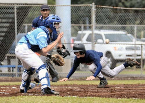 rnm-090219_0002 Keaau's Jesse Huihui scores on a sacrifice fly by Jonathan Chow. Tanner Benbow of Kealakehe awaits the arrival of the ball.