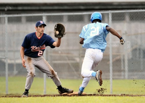 rnm-090219_0004 Close play at first base. The Waverider's Tyson Pierceswift was called safe just as the Cougars' Matthew Vidinha caught the ball.