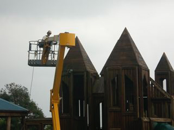 higashiharaspray Volunteer Larry Webb hitting the high spots with a final touch of sealer on the 40-foot snorkel lift. (Photo courtesy of Cliff Kopp)