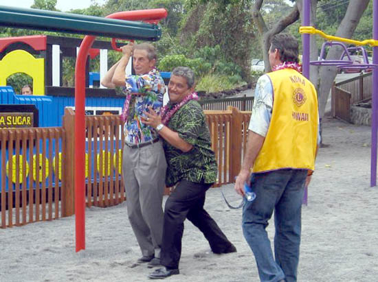 koppkenoilovein Cliff Kopp gets push from Mayor Billy Kenoi as Bob Lovein, Kona Lion and playground volunteer, looks on. Kopp was the first to test out the new 20-foot zipline, which is actually designed for keiki! (Hawaii247.com photo courtesy of Cliff Kopp)