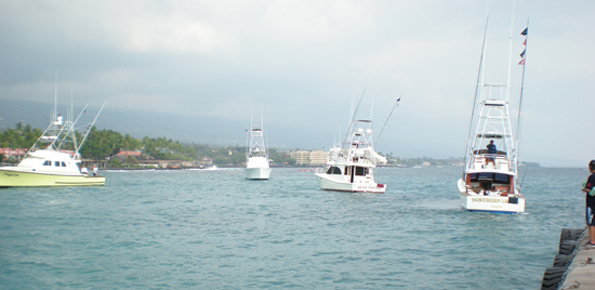 HIBT1Lineup Fishing boats line up in Kailua Bay, waiting to check in their anlgers after the first day of the 50th anniversary Hawaiian International Billfish Tournament. (Hawaii247.com photo by Karin Stanton)