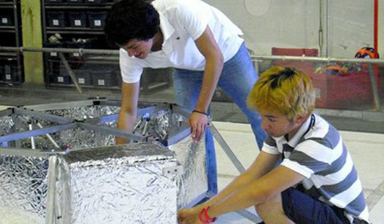 LunarRoverStudents Kelson Lau and Jordan Olive are developing technology that will be implemented on NASA's Lunar Micro Rover. (Photo courtesy of the Governor's Office)