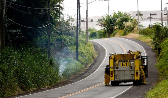 20090810_waianuenue-power-line-down Fire/rescue crews await HELCO to arrive and shut-off power to an electrical line which went down on Waianuenue Avenue between Hospice of Hilo and Hilo Medical Center. The live power line started a grass fire alongside the road.