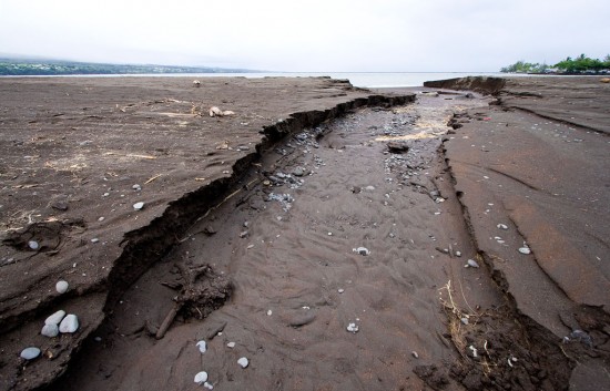 20091012_hilo-bay Heavy rains caused some erosion of the beach at Hilo Bay. The afternoon tide coming in worked to dull the jagged edge of the cut in the sand. Photography by Baron Sekiya for Hawaii 24/7.