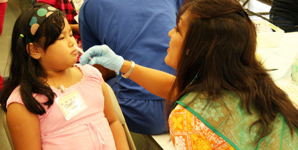 H1N1SchoolShots A student at Kalihi Kai Elementary School receives her influenza vaccination. The Department of Health is conducting H1N1 vaccination clinics at schools statewide. (Photo courtesy of The Governor's Office)