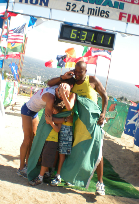 UltramanRibeiroHug Ultraman champion Alexandre Ribeiro gets a hug from sons Kailani and Kaipo, and friend Jose Ponciano. (Hawaii 24/7 photo by Karin Stanton)
