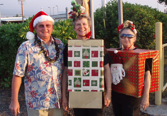 CoffmanEvansParade State Reps. Denny Coffman and Cindy Evans (center) were among the public officials celebrating the holiday season during Saturday's festivities. (Hawaii 24/7 photo courtesy of Margaret Masunaga)