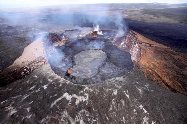20110629_perched_lake Aerial view looking southwest into Pu‘u ‘O‘o crater with its lava lake (shiny surface) perched 5-8 m above the surrounding lava flows. The lake and flows have filled in the crater vertically at least 100 m (328 ft) since the crater collapsed on March 5, and still have about 12 m (39 ft) to reach the previous high point and begin spilling into the pits on the western crater rim (in background). The perched lava lake and high emissions of sulfur dioxide gas make the Pu‘u ‘O‘o area extremely hazardous. Ground access is restricted by Hawai‘i Volcanoes National Park and the Kahauale‘a Natural Area Reserve managers.