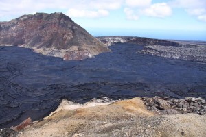20110721_7599_torr_L Looking south toward the MLK pit (straight) and Puka Nui pit (right). Lava is only a few meters (yards) away from overtopping the pits and flowing onto the southwest flank of Pu‘u ‘Ō ‘ō. Photo courtesy of USGS/HVO