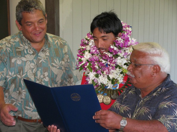 louie-perry-kenoi-blas Louie Perry III is greeted by Mayor Billy Kenoi (left) and County Councilman Fred Blas (right) and well-wishers at Hilo airport on July 6, 2011. Mayor Kenoi and Councilman Blas declared July 6, 2011 to be "Louie Perry III Day." Perry, of Pahoa, returned home from the Special Olympics World Summer Games in Athens, Greece with three Gold Medals in track and field events.