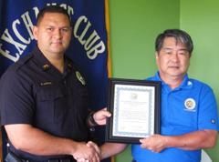 Officer Erhard Autrata Aloha Exchange President Dale Tokuuke presents an 'Officer of the Month' award to Officer Erhard Autrata
