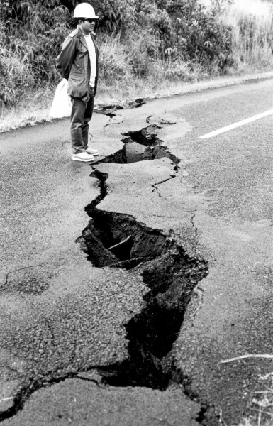 196512_usgs-chainofcratersroad-cracks Hawaii Volcanoes National Park. February 1969 eruption of Kilauea Volcano. New opening of a preexisting crack cutting the Chain of Craters Road 400 meters east of Aloi Crater, near the eruptive fissure. The measured amount of an opening at a station just off the road is 11.6 centimeters. Note the roots extending across the crack and the remnant of an asphalt patch used to cover the crack after it opened in December 1965. USGS Photo