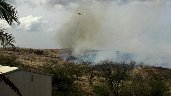 20120218_waikoloa-fire-helo The Fire Department's Chopper Two uses a Bambi Bucket to perform water drops on a fire near Waikoloa Village. Photo by Bonnie Palos | Special to Hawaii 24/7