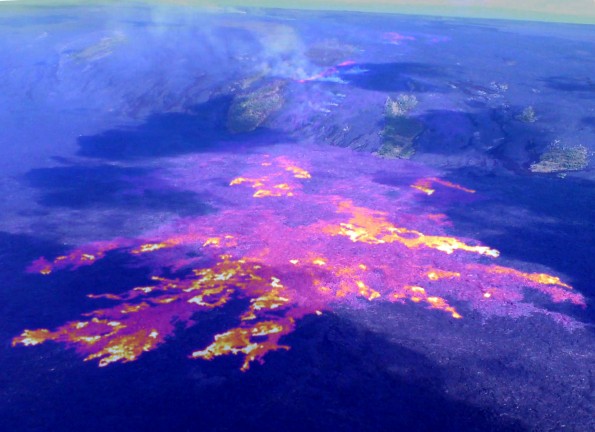 20120426_coastal-plain-thermal Active flows are still spread out across a broad area on the coastal plain, and advancement towards the ocean remains relatively slow. This image is a composite of a thermal image and normal photograph, with white and yellow areas showing active pahoehoe breakouts, and red areas showing inactive, but still warm, portions of the flow surface. On Thursday (April 26), the flow front (lower left corner of image) was about 900 meters (0.6 miles) from the ocean. The field of breakouts shown here is about 1.4 km (0.9 miles) wide. On the pali, a line of fuming areas marks the path of the lava tube through Royal Gardens subdivision. The fume from these sources partly obscures another narrow breakout on the pali. Photo courtesy of USGS/HVO