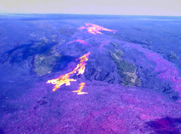 2012051_usgs-coastal-pali-combo This composite image combines a thermal image with a normal photograph, and shows the recent breakouts on the pali and coastal plain in Royal Gardens subdivision. The two large vegetated areas in this view are some of the only remaining portions of Royal Gardens not covered by lava. The bright white and yellow areas show the breakouts active during Thursday's (May 31) overflight. The large central breakout had an impressive channelized a‘a flow reaching the base of the pali. Photo courtesy of USGS/HVO