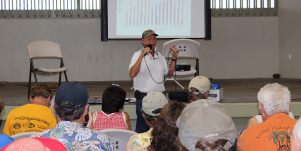 Tommy Greenwell speaks to farmers at Kona Coffee Farmers Association's annual expo at Old Kona Airport. (Hawaii 24/7 photo by Karin Stanton)