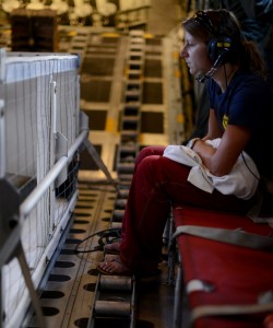 NOAA Veterinarian Michelle Barbieri travels from the Big Island to Oahu aboard an HC-130 Hercules airplane from Coast Guard Air Station Barbers Point with a Hawaiian monk seal Feb. 1, 2012. The Hawaiian monk seal was suffering respiratory problems and Coast Guard air crews transported him to Oahu for medical care. U.S. Coast Guard photo by Petty Officer 2nd Class Eric J. Chandler.