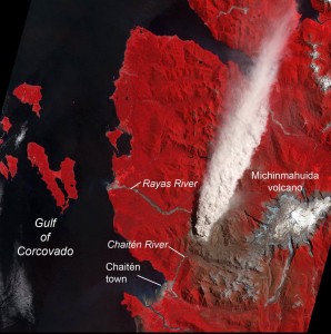 This false-color image obtained from NASA’s Terra satellite on January 19, 2009, shows an ash plume (white plume spreading north, top) erupting from Chaitén Volcano. Red color indicates green vegetation. The brown color east and southeast of the volcano (lower left) shows extensive forest damage (400 square km; 155 square miles) from the early explosive eruptions, caused by ash fall and possibly by chlorine released from the magma. Scientists have concluded that magma fueling Chaiten’s eruptions ultimately originates beneath Michinmahuida Volcano, 17 km (10 miles) east of Chaitén. The town of Chaitén was evacuated a few days after the eruption began on May 2, 2008, before lahars and floods inundated most of the town.