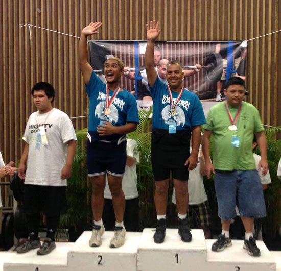 Quentin Wong (left) and Ray Donager (right) pose for a picture on the first and second place steps at the Special Olympics Summer Games award ceremony. (Photo courtesy of Denise Lindsey)