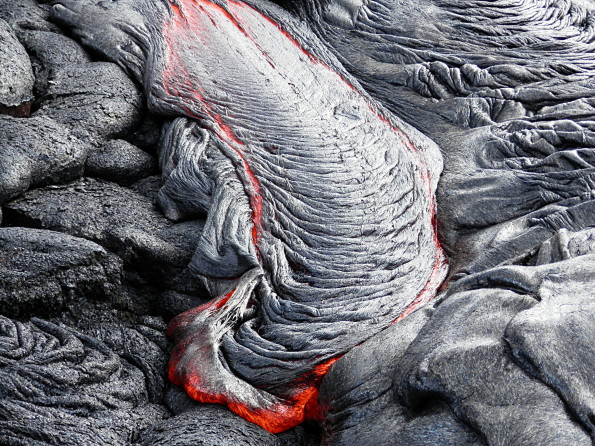 Active pāhoehoe breakouts are scattered across portions of the Kahaualeʻa 2 flow. This photo shows a nice example of ropy pāhoehoe active near the flow margin. Photo courtesy of USGS/HVO