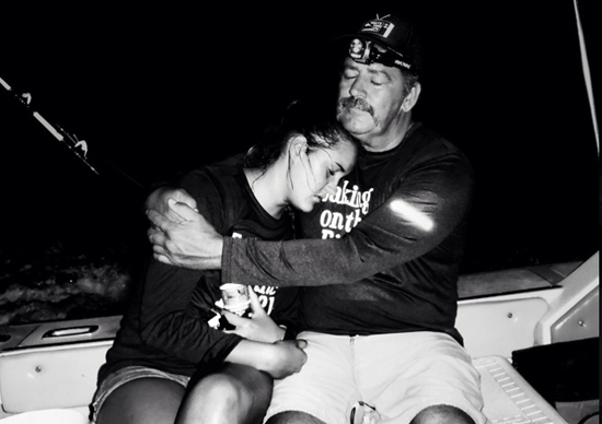 Leahi and Charlie Camacho share a hug before she begins her epic swim. (Photo courtesy of Wendy Smith)