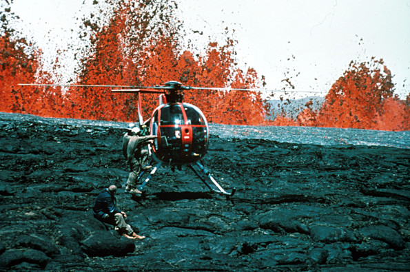 Hawaii Volcanoes National Park. 1984 eruption of Mauna Loa Volcano. Hawaiian Volcano Observatory geologists at lava fountains. Helicopters provided access to remote areas of the eruption and were essential for safety. Photo by R.B. Moore, 1984. Photo courtesy of USGS